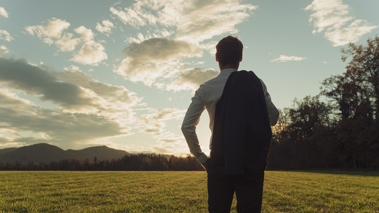 man looking at sunrise