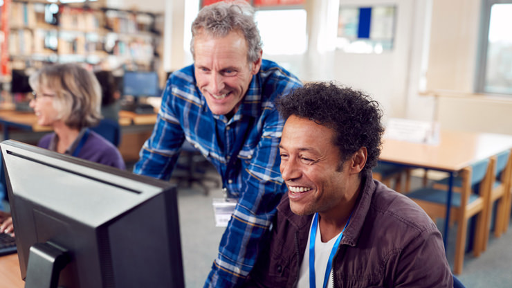 mentor with student at computer